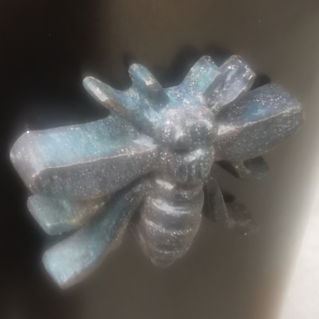 Close up of bee on large bollard near Town Hall, Albert Square