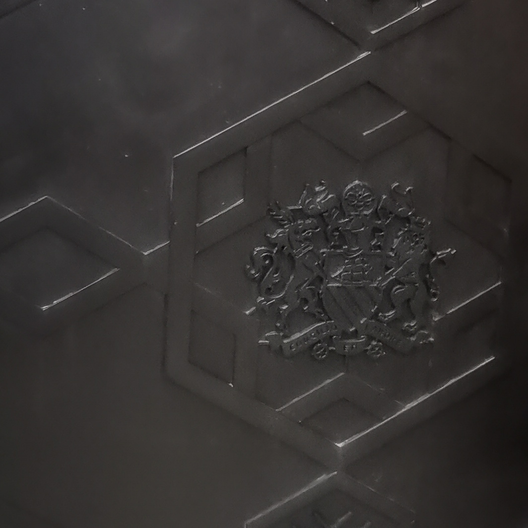 Close up of Manchester Coat of Arms, with only one bee, on big back cabinet, Albert Square
